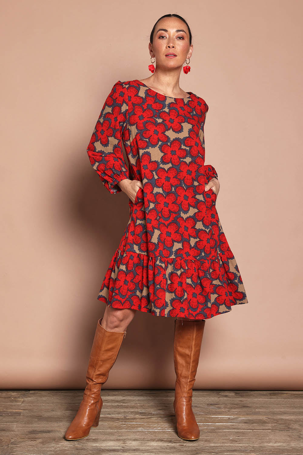 Model Katie wearing size 10 of the Cotton Frill Hem Dress in colour Poppy (Red), from the front, showing the whole outfit