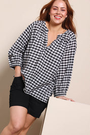 Model Georgiel wearing size 10 of the Cotton Gingham Blouse – Black in colour Black, in a cropped view