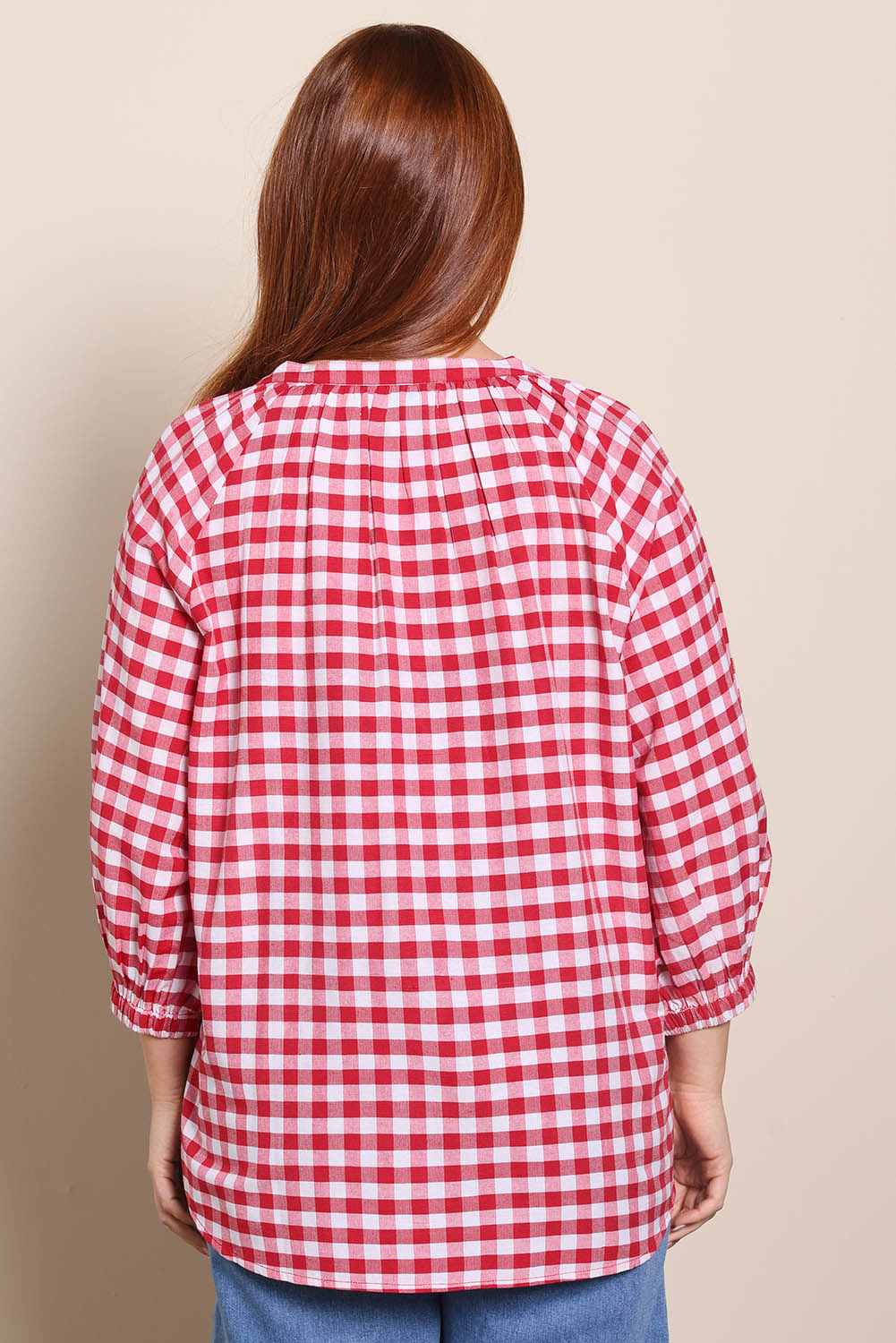 Model Georgiel wearing size 10 of the Cotton Gingham Blouse – Red in colour Red, from the back