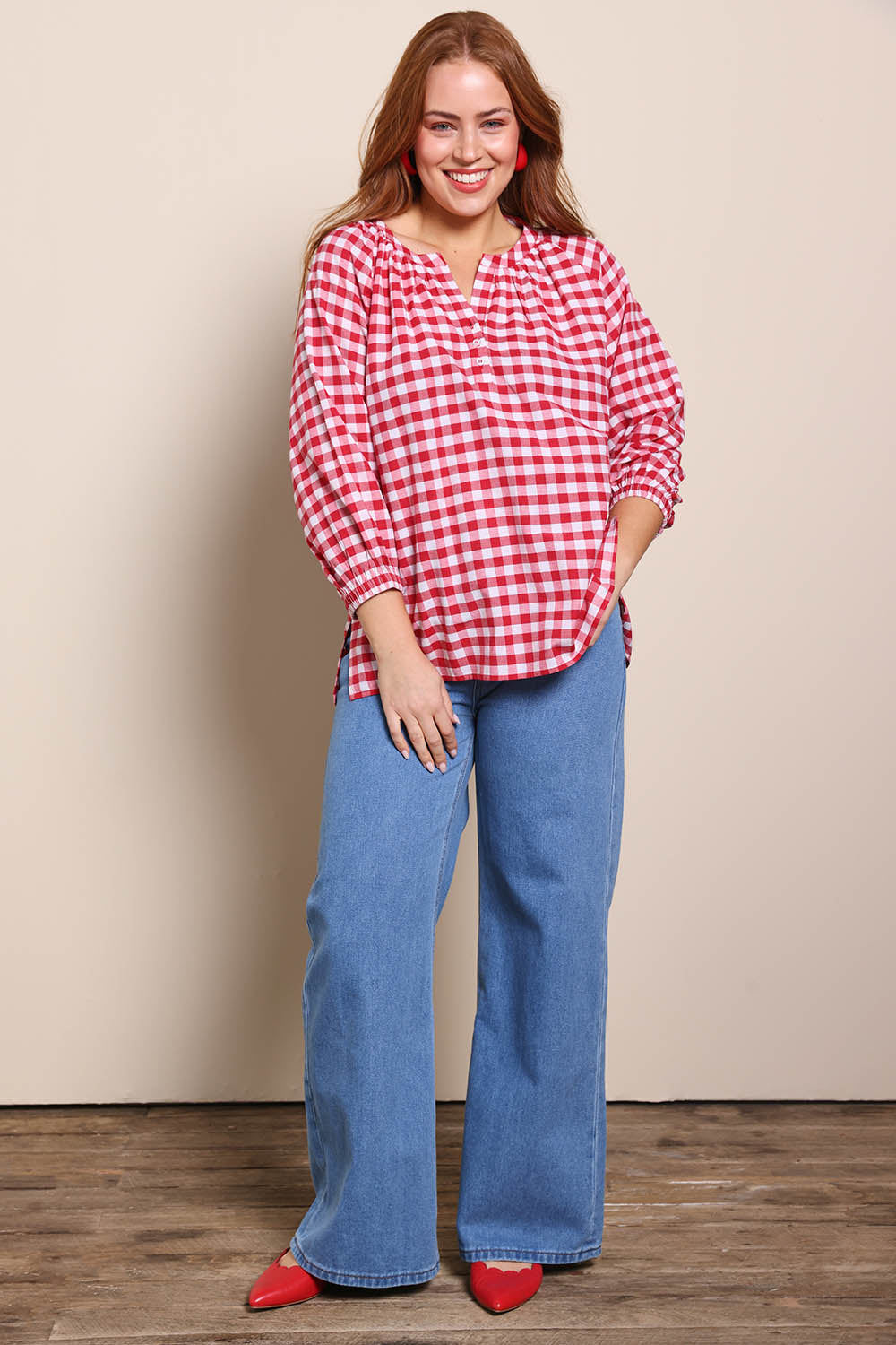 Model Georgiel wearing size 10 of the Cotton Gingham Blouse – Red in colour Red, from the front