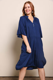 Model Georgiel wearing size 10 of the Relaxed Tiered Dress – Peacoat in colour Peacoat, from an angle