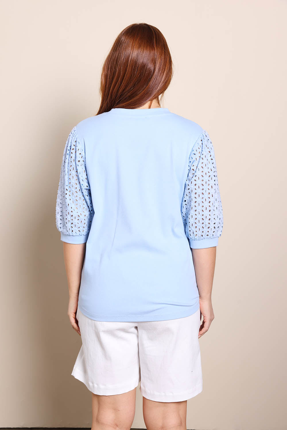 Model Georgiel wearing size 10 of the Embroided Sleeve Tee – Blue in colour Blue, from the back
