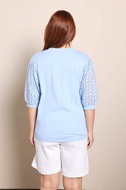 Model Georgiel wearing size 10 of the Embroided Sleeve Tee – Blue in colour Blue, from the back