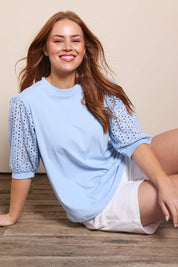 Model Georgiel wearing size 10 of the Embroided Sleeve Tee – Blue in colour Blue, in a cropped view