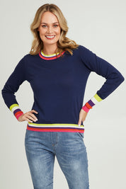 Model Grace wearing size S of the Emma Sweater in colour Rainbowstp (Blue), from the front, cropped image