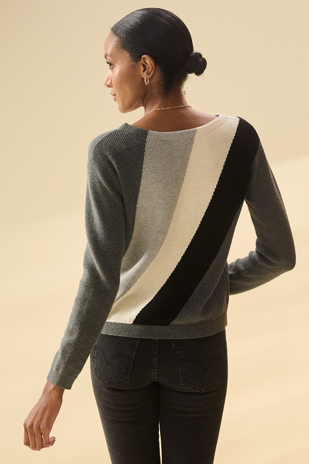 A model wearing the Devon Cotton Cashmere Sweater in colour Dstripes (Grey), from the back