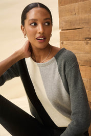 A model wearing the Devon Cotton Cashmere Sweater in colour Dstripes (Grey), from the front, showing the whole outfit