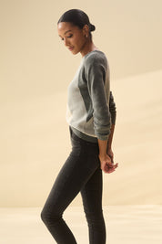 A model wearing the Devon Cotton Cashmere Sweater in colour Dstripes (Grey), from the front, showing the whole outfit