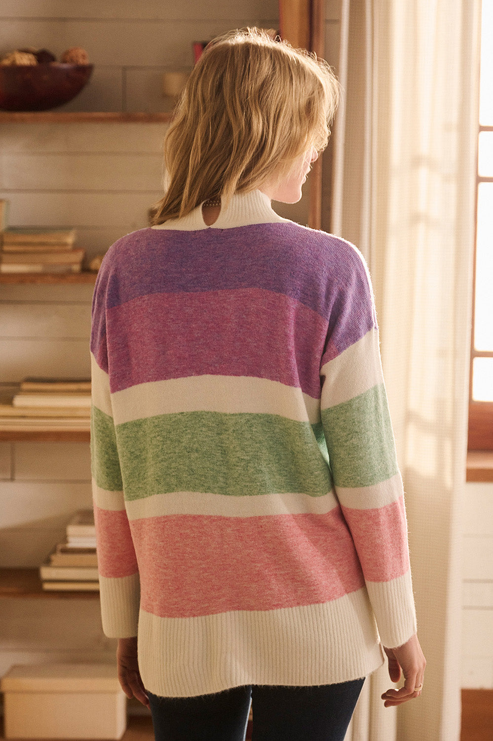 A model wearing the Mock Neck Tunic in colour Sunrise, from the back