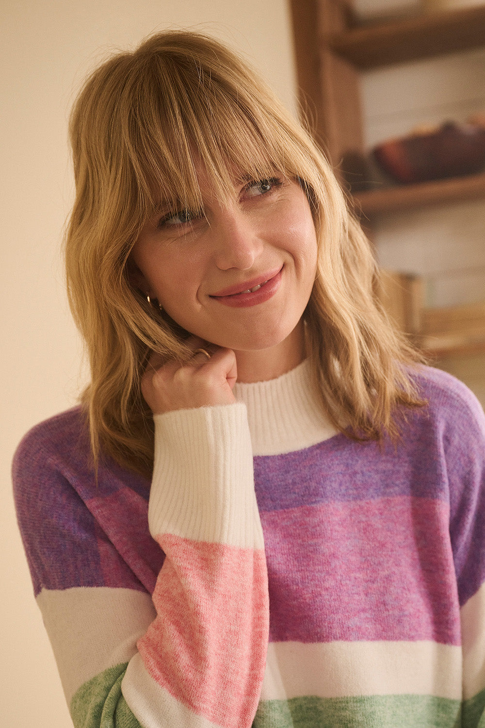 A model wearing the Mock Neck Tunic in colour Sunrise, from the front, cropped image