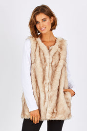 Model Nikki wearing size S of the Faux Fur Vest in colour Fur, from the front, cropped image