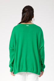 A model wearing the Haven Jumper in colour Oasis (Green), from the back