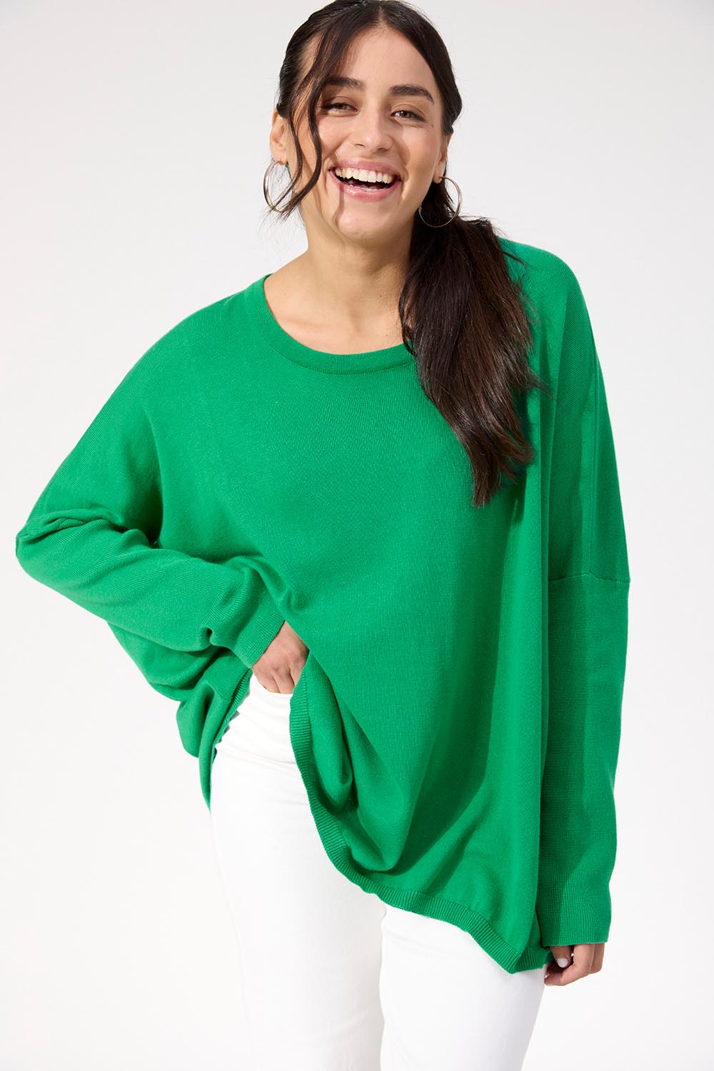A model wearing the Haven Jumper in colour Oasis (Green), from the front, cropped image