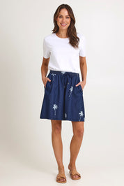 Model Madeline wearing size S of the Montego Denim Short in colour Indigo (Blue), from the front, showing the whole outfit