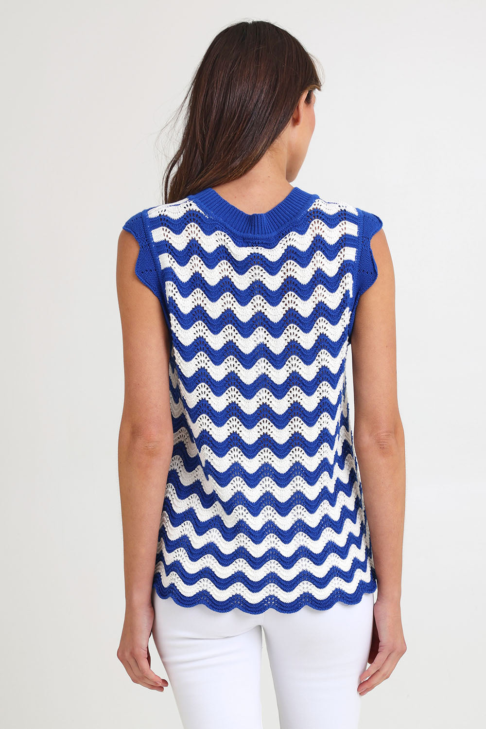 Model Madeline wearing size S of the Jamaica Cotton Knit Top in colour Azul, from the back