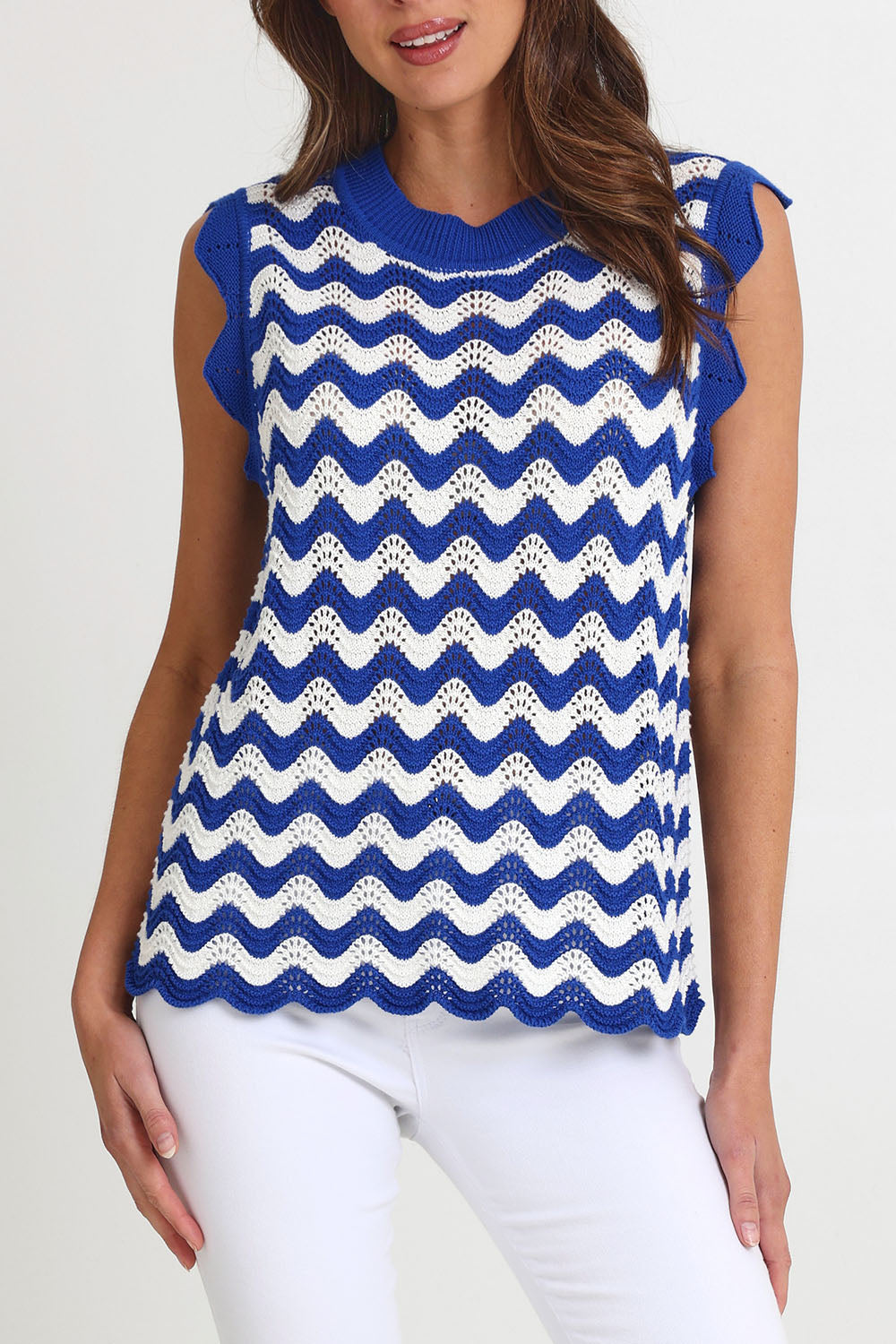Model Madeline wearing size S of the Jamaica Cotton Knit Top in colour Azul, from the front, cropped image