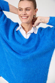 A model wearing the Lyon Relaxed Jumper in colour Cobalt (Blue), from the front, cropped image