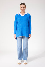 A model wearing the Lyon Relaxed Jumper in colour Cobalt (Blue), from the front, showing the whole outfit