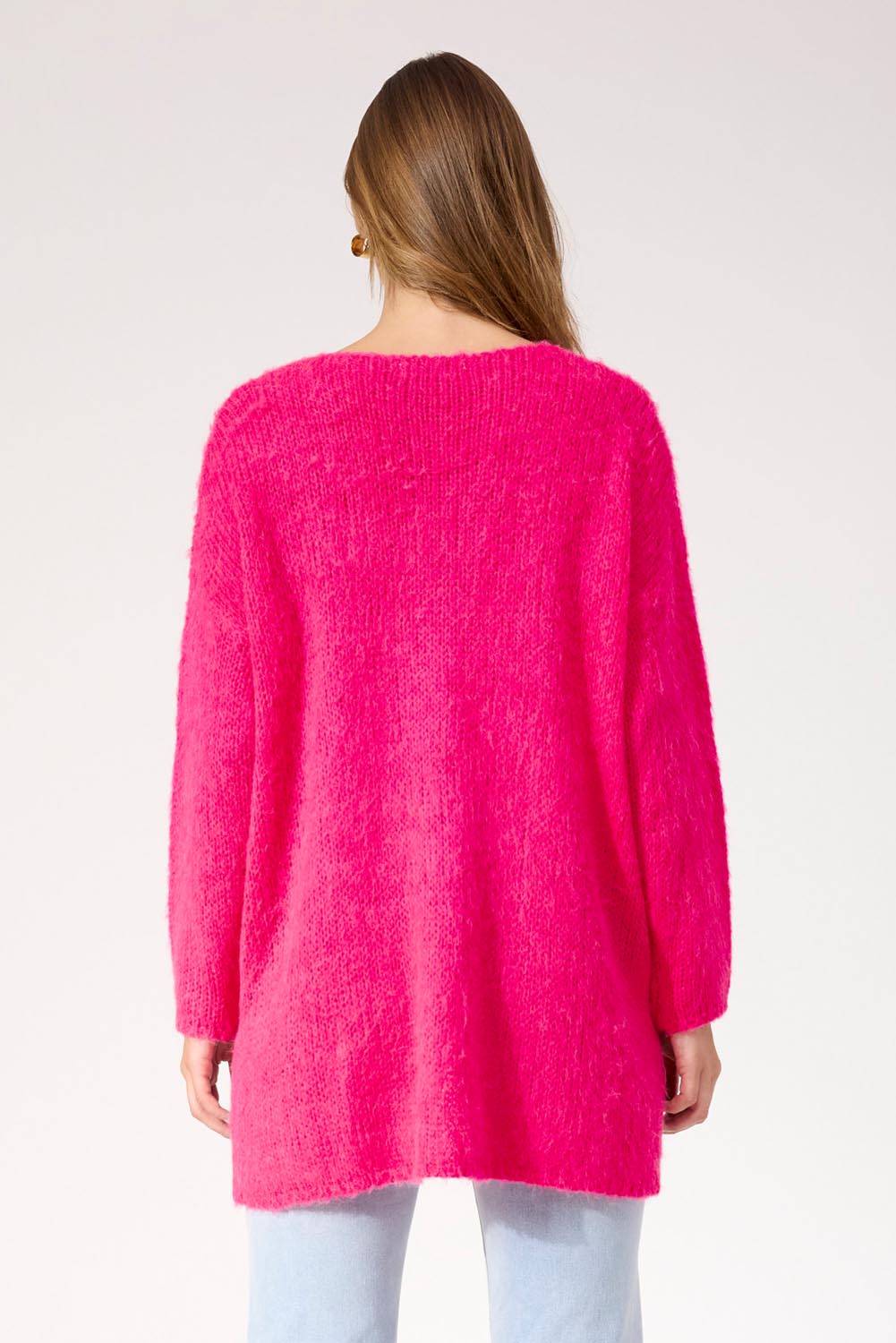 A model wearing the Lyon Relaxed Jumper in colour Hotpink (Pink), from the back