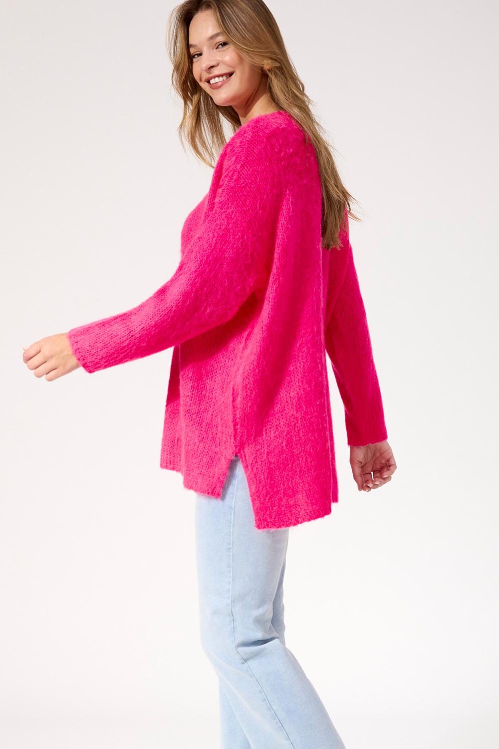 A model wearing the Lyon Relaxed Jumper in colour Hotpink (Pink), from the front, cropped image
