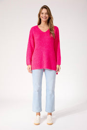 A model wearing the Lyon Relaxed Jumper in colour Hotpink (Pink), from the front, showing the whole outfit