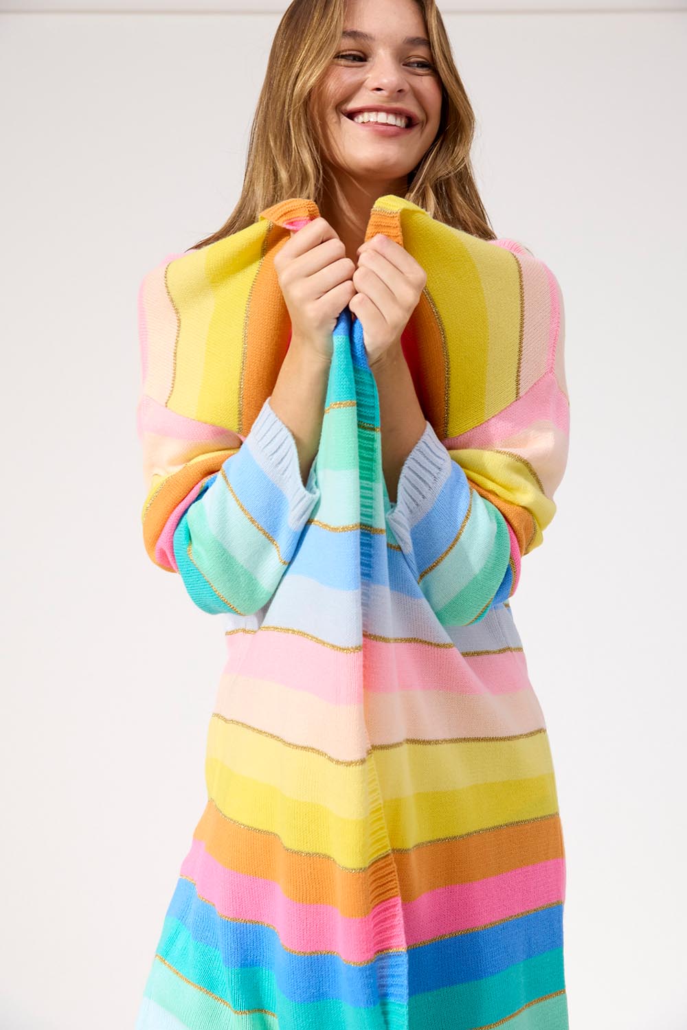 A model wearing the Niseko Cardigan in colour Pastel, from the front, cropped image