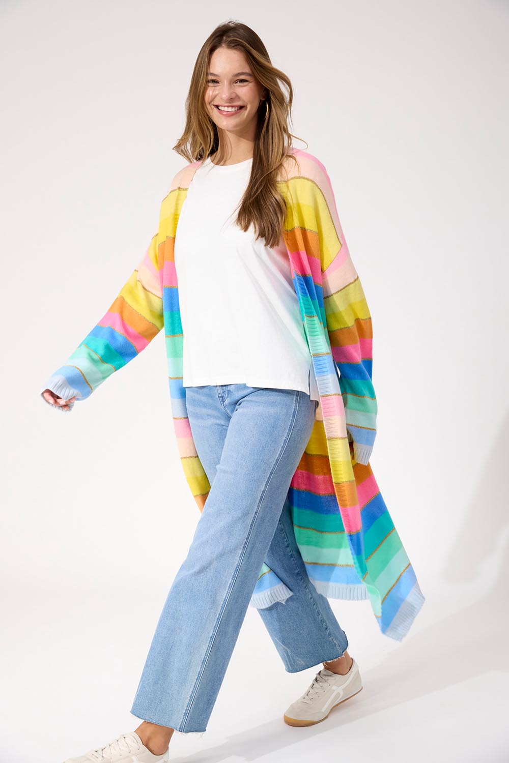 A model wearing the Niseko Cardigan in colour Pastel, from the front, showing the whole outfit