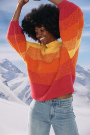 A model wearing the Valenza Jumper in colour Sunrise, from the front, showing the whole outfit