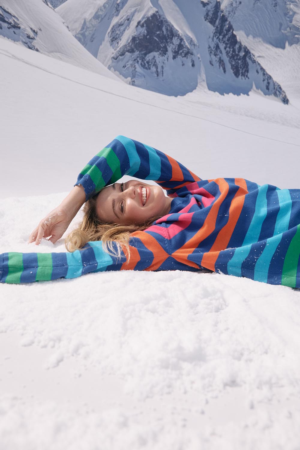 A model wearing the Vermont Stripe Jumper in colour Cobalt, from the front, showing the whole outfit