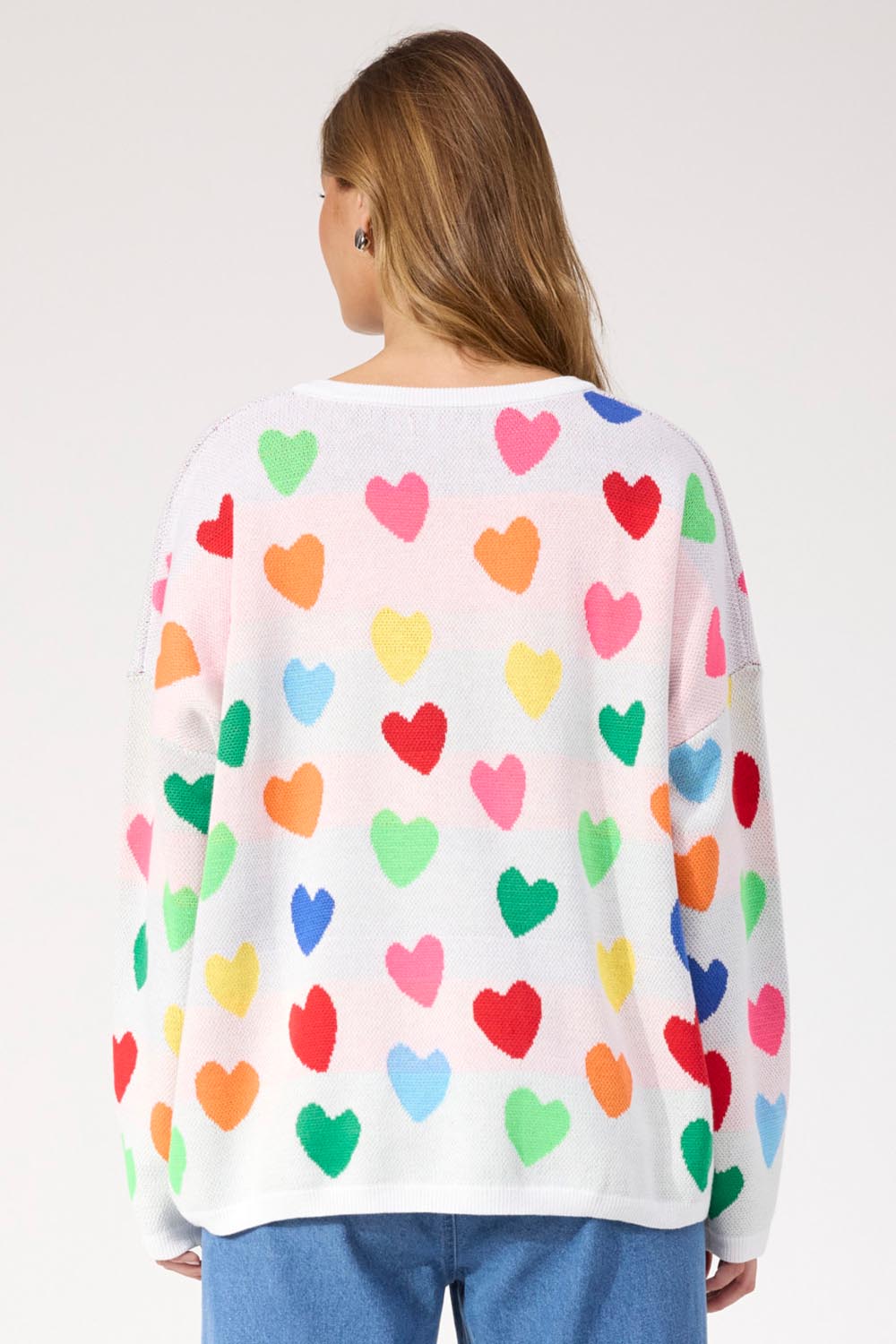 A model wearing the Alaska Relaxed Heart Jumper in colour Rainbow, from the back