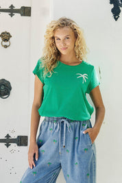 Model Genericm wearing size sample of the Congo Graphic Tee – Green in colour Green, in a cropped view