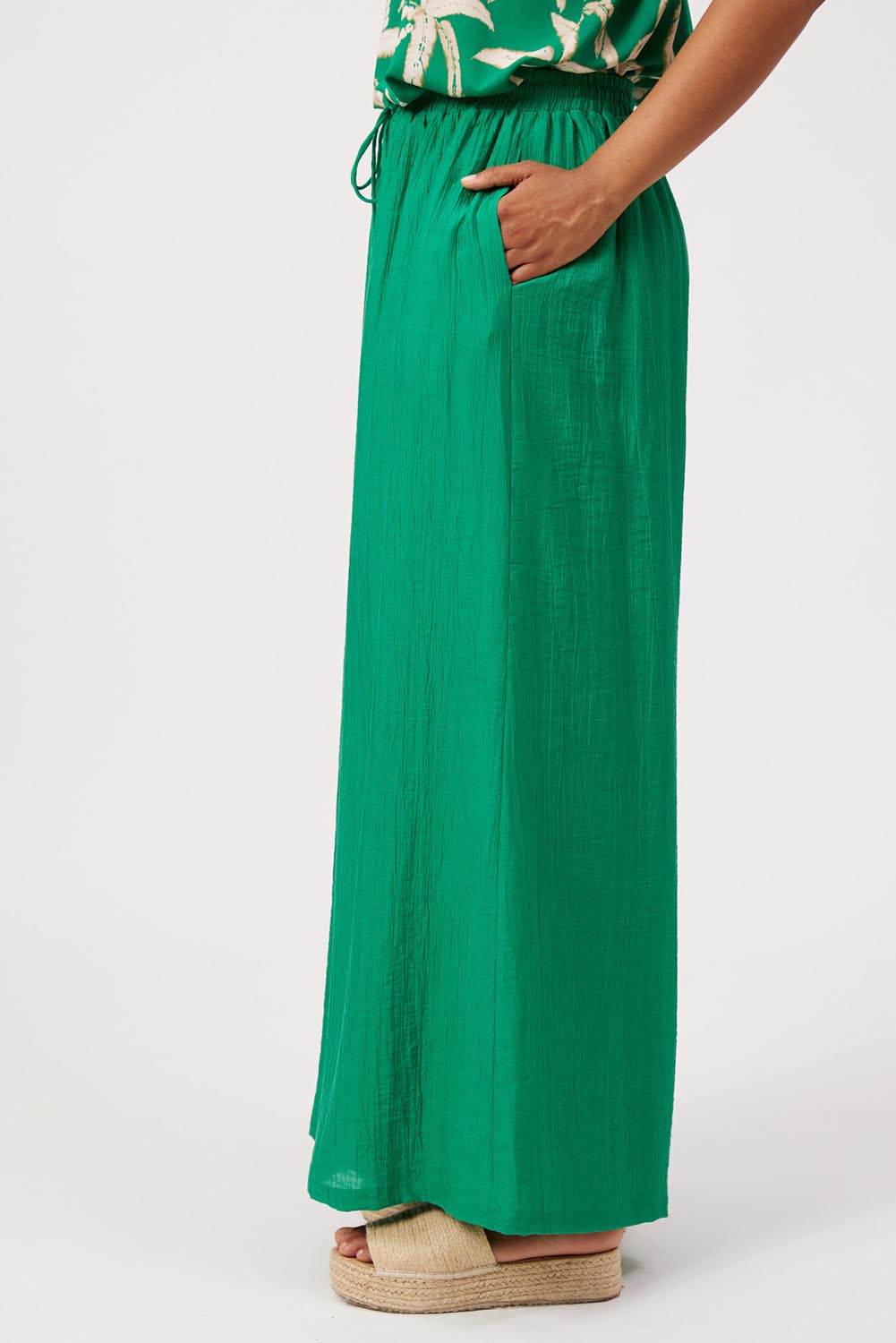 Model Genericm wearing size sample of the Kenya Palazzo Pant – Green in colour Green, from an angle