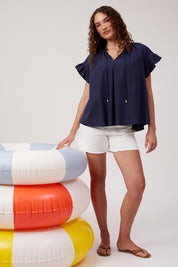 Model Genericm wearing size sample of the Crete Top – Navy in colour Navy, from the front