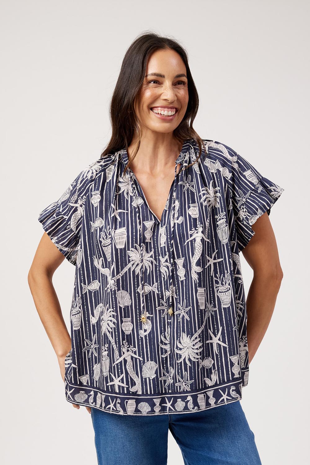 Model Genericm wearing size sample of the Crete Top – Sea in colour Sea, in a cropped view
