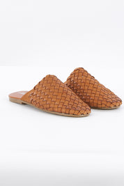 A model wearing size 37 of the Barland Woven Leather Mule in colour Tan, from the front, showing the whole outfit