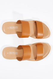 A model wearing size 38 of the Dakota Leather Sandal in colour Tan, from the front, showing the whole outfit
