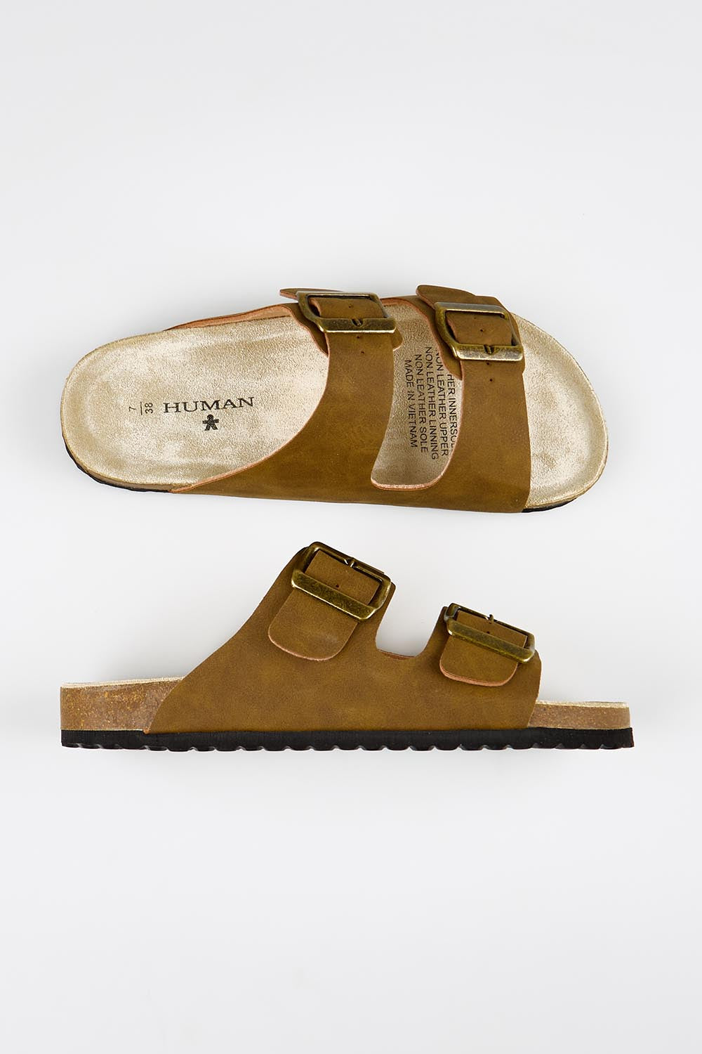 Model Genericm wearing size sample of the Ibiza Slide - Taupe in colour Taupe, from an angle