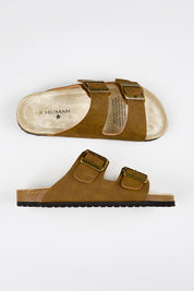 Model Genericm wearing size sample of the Ibiza Slide - Taupe in colour Taupe, from an angle