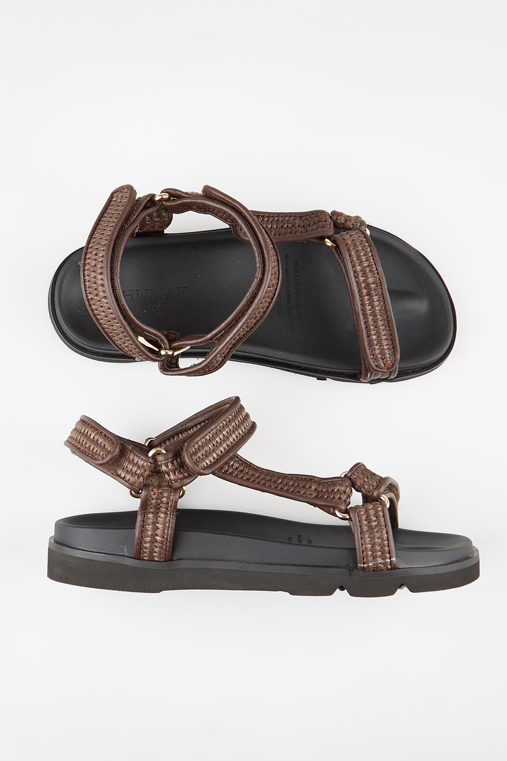 Model Genericm wearing size sample of the Reva Sandal - Chocolate in colour Chocolate, from an angle