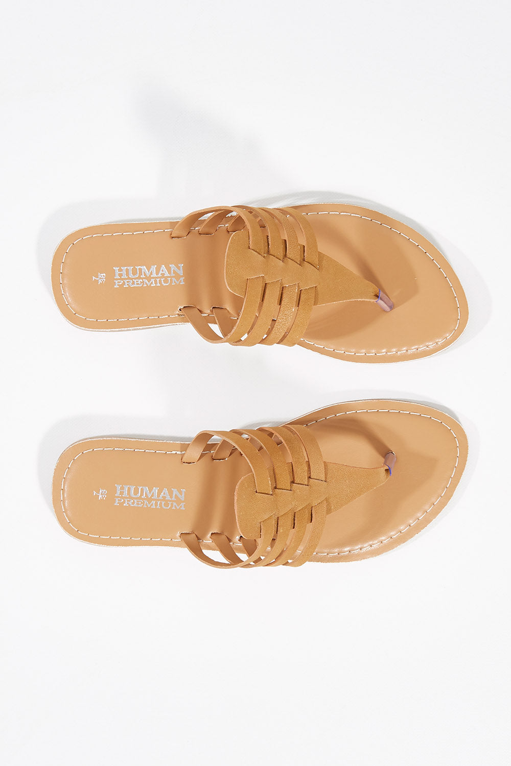 A model wearing size 37 of the Sonya Thong Sandal in colour Tan, from the front, showing the whole outfit