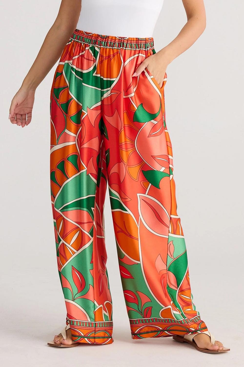 A model wearing the Playa Pant in colour Rainforest, from the front, cropped image