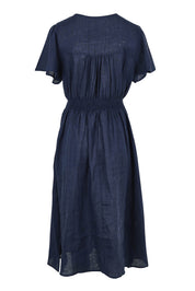 Product shot of the Blossom Linen Dress in colour Navy (Blue), from the back