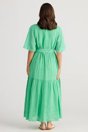 A model wearing the Lynwood Linen Dress in colour Apple (Green), from the back