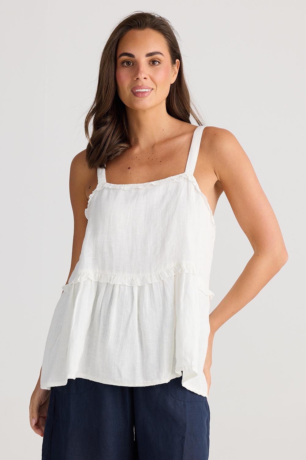 A model wearing the Alita Linen Top in colour White (White), from the front, cropped image