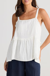 A model wearing the Alita Linen Top in colour White (White), from the front, cropped image