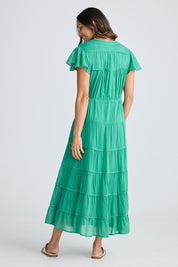 A model wearing the Delilah Cotton Dress in colour Jadegreen (Green), from the back