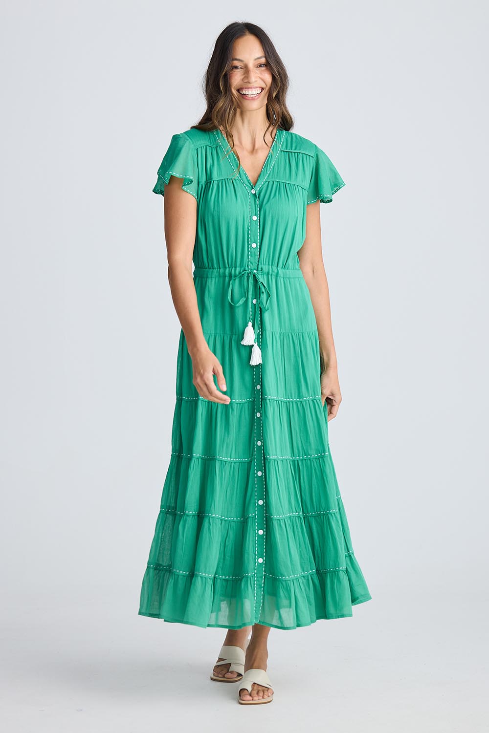 A model wearing the Delilah Cotton Dress in colour Jadegreen (Green), from the front, showing the whole outfit