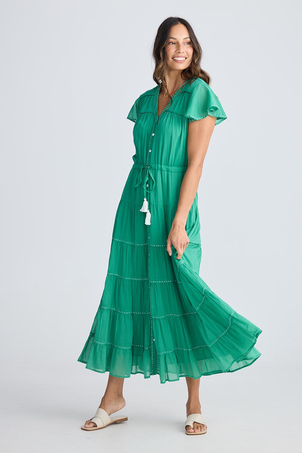 A model wearing the Delilah Cotton Dress in colour Jadegreen (Green), from the front, showing the whole outfit