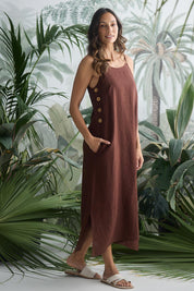 A model wearing the Cliffside Linen Maxi Dress in colour Chocolate, from the front, showing the whole outfit