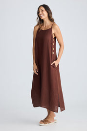 A model wearing the Cliffside Linen Maxi Dress in colour Chocolate, from the front, showing the whole outfit